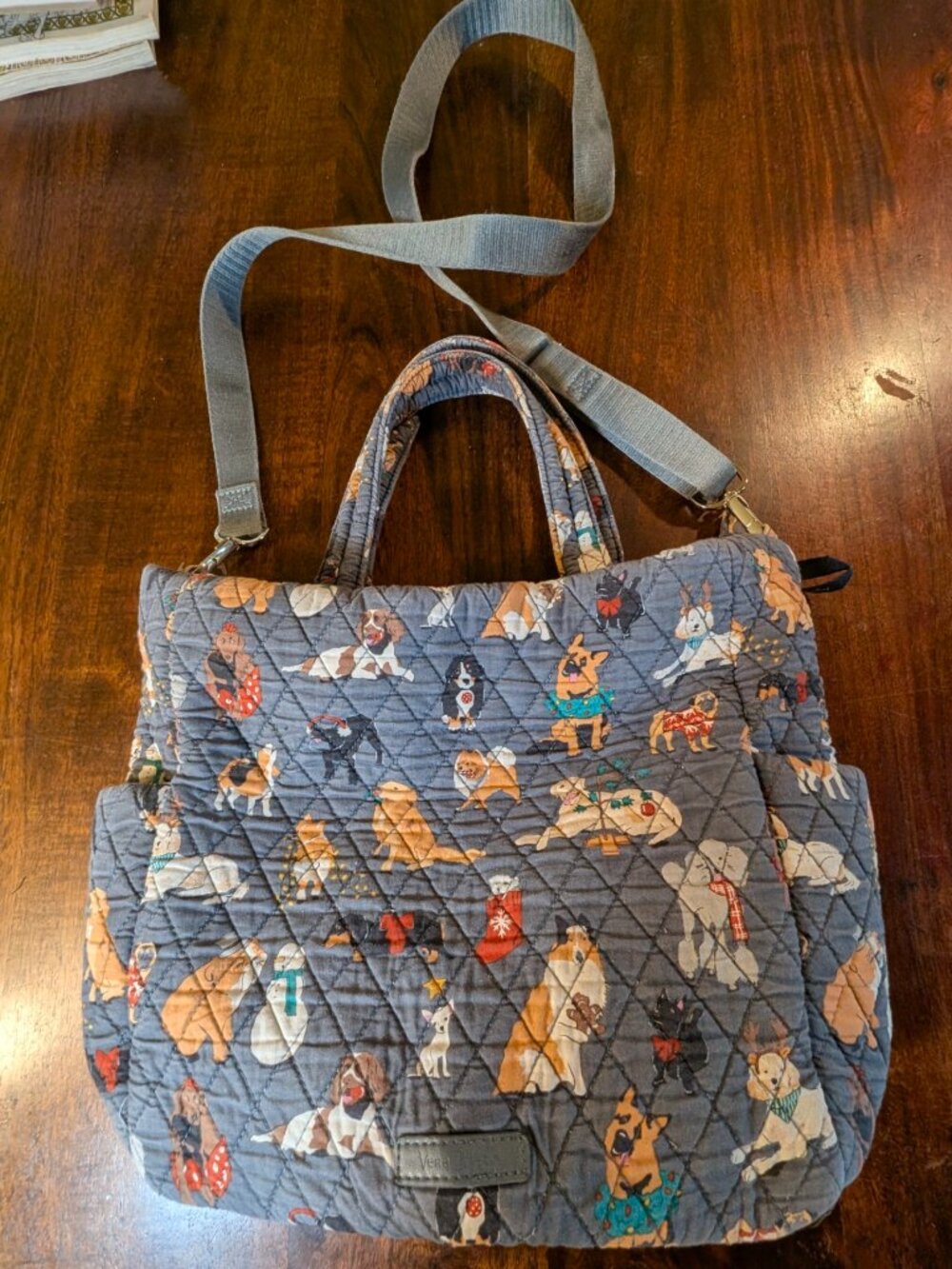 The Vera Bradley Dogs Crossbody Bucket Bag is a stylish and practical accessory